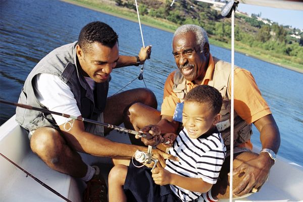 Men and a boy fishing together.