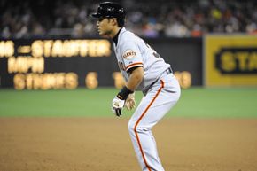 Kensuke Tanaka of the San Francisco Giants leads off first base after hitting a single during the fourth inning of a baseball game against the San Diego Padres. See more baseball pictures.