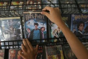 A child picks up a "Harry Potter" DVD.