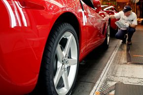 Richard Mayberry gives a Corvette a close look on the final inspection line at the General Motors Corvette plant in Bowling Green, Ky.