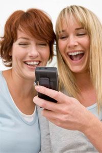 women looking at cell phone screen