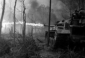 Flame tanks of the 1st Tank Battalion attack No-name Village, in the Quang Ngai province of Vietnam, during Operation Doser.