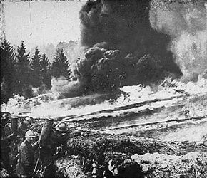 French soldiers make a gas and flame attack on German trenches in Flanders, Belgium, during WWI.
