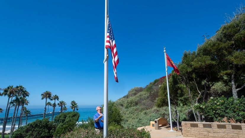 mayor lowering flag to half-staff