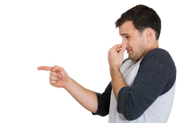 Man holding nose and pointing to out-of-frame smell perpetrator