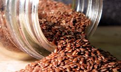 Flax seed spilling out of a mason jar.