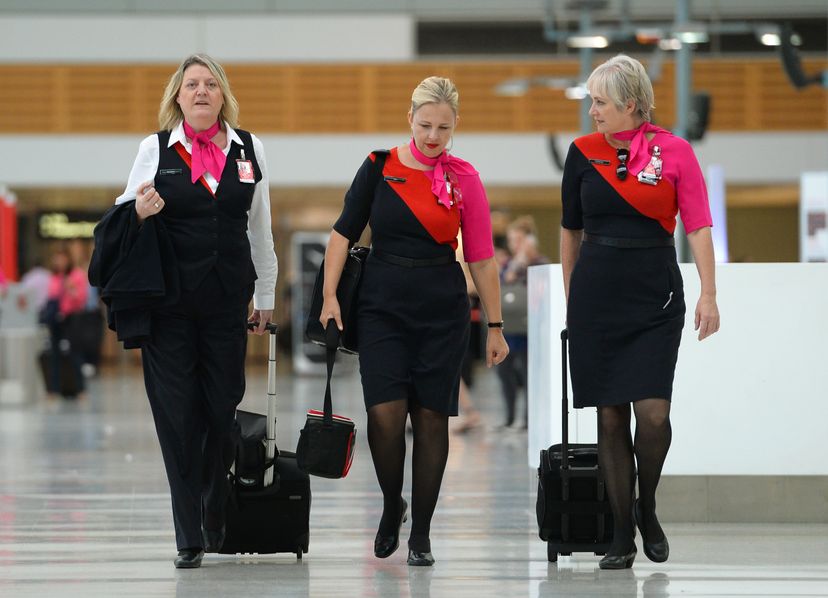 Qantas flight attendants walk through the terminal of the Sydney domestic airport in Australia in 2014. The image of flight attendants has changed a lot over the years.