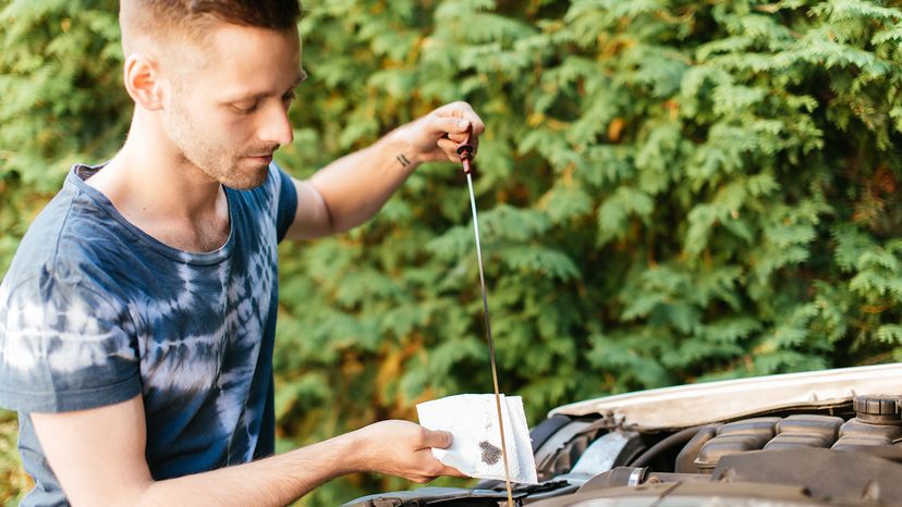 Man checking car oil