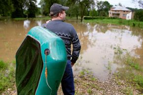 homeowner surveying flood damage