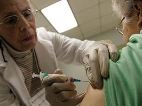 A Chicago woman receives a free flu shot from a nurse