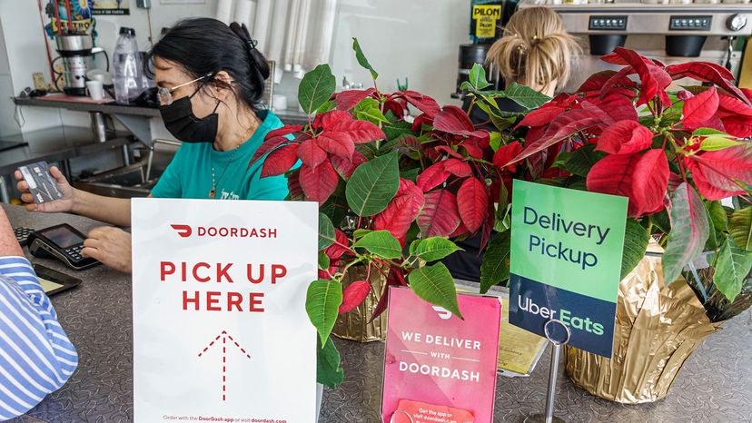signs for food delivery services DoorDash and Uber Eats