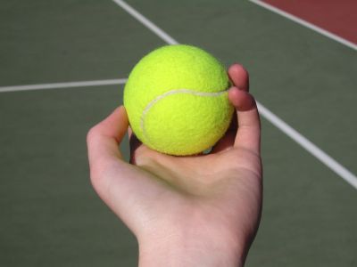 hand holding tennis ball
