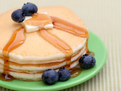 pancakes topped with butter, syrup, and blueberries