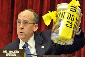 U.S. Rep. Greg Walden (D-OR) holds a sample of recalled food products during a hearing on the salmonella outbreak associated with peanut butter in 2009.