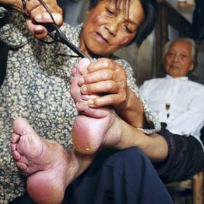 women with bound feet getting foot cleaned