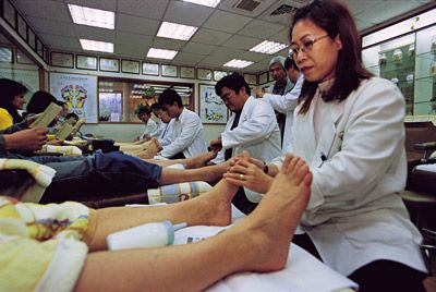 Reflexology therapists treat patients in Taipei.