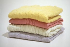 Properly folded sweaters will keep their shape and form better than those stored on hangers.