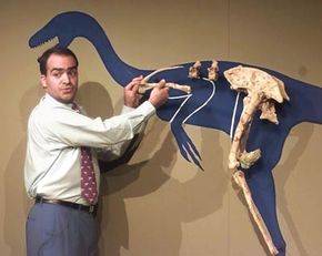 Professor Fernando Novas demonstrates his theory of how birds are directly descended from dinosaurs during a press conference at the National Geographic Society in Washington, D.C.