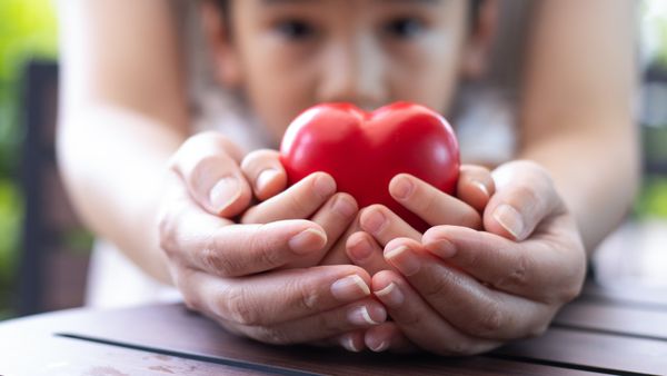 Mother and Foster Child Holding Hands with Heart in it