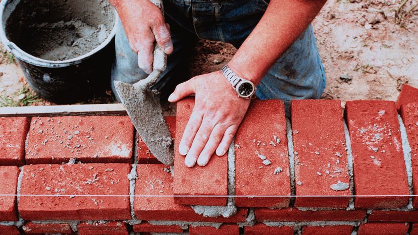 A man doing bricklayering.