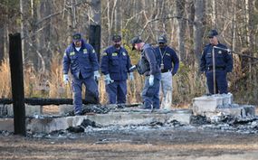 Investigators at the site of a fire