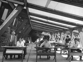 Wright advises members of the Taliesin Fellowship, hard at work at their drafting boards.