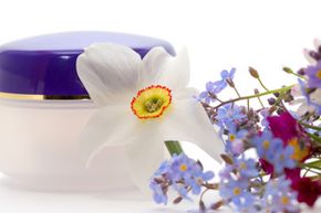 blank container for cosmetic cream with flowers