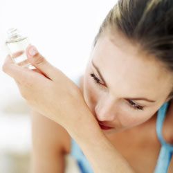 woman using perfume