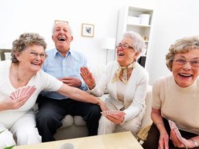 group of elderly people playing cards