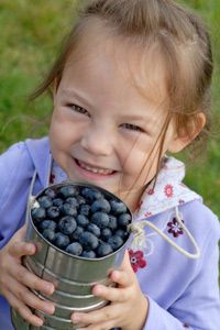 girl with pail of blueberries