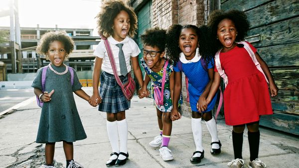 black girls standing on street smiling