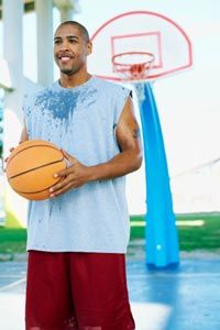 Sweating man playing basketball