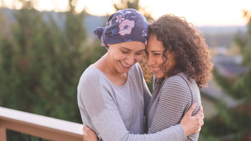 woman with cancer hugging sister