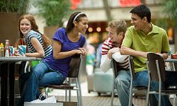 Teenage friends hanging out at mall food court. 