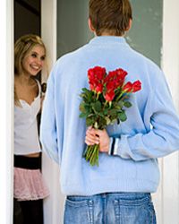 Guy waiting at girl's door with flowers. 