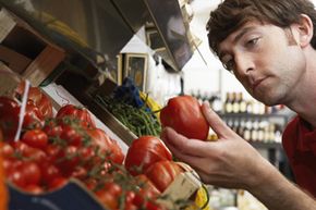 Man examining tomato