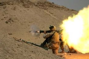 Soldier fires a handheld rocket launcher in training