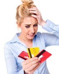 young woman holding 3 credit cards looking worried