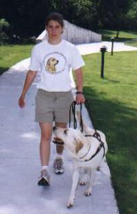 An instructor and a future guide dog practice walking 
