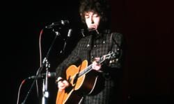 bob dylan playing an acoustic guitar