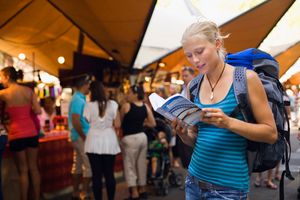 young woman with guide book