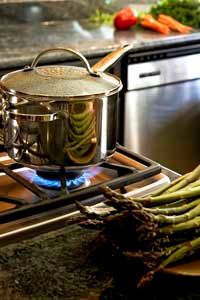 Electric stove with a pot on the burner in a kitchen.