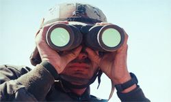 Even with radar, a pair of binoculars still comes in handy for this U.S. soldier during the Gulf War.
