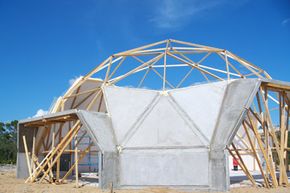 Dome homes may have nontraditional designs, but they can still incorporate traditional construction materials, such as wood beams and concrete.