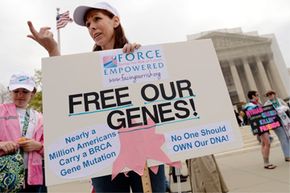 Woman with "Free Our Genes" sign