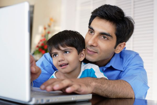 father and son look at computer