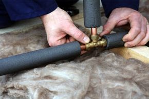 plumber working with copper water pipes