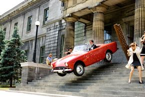 Steve Carell flies in one of the classic sports cars driven in the movie.