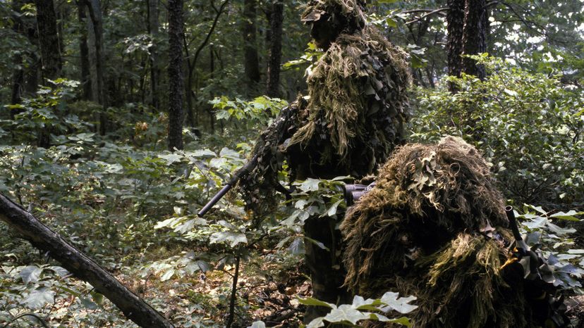 Sniper team wearing camouflage ghillie suits