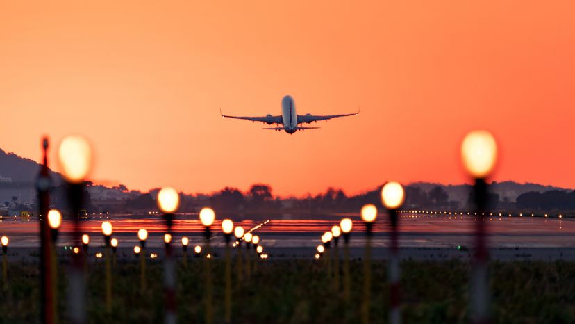 Airplane taking off at sunrise